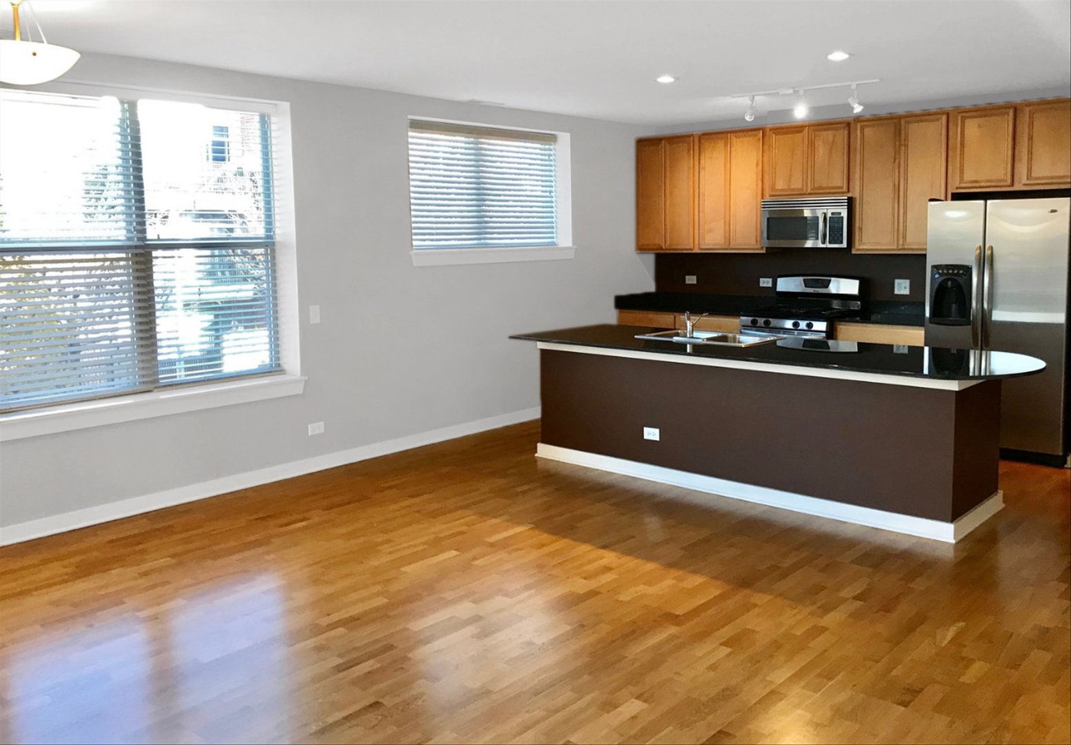 2231 West Maypole Avenue, Unit 201 Chicago, IL 60612 - Photo 2 of 10 a kitchen with stainless steel appliances granite countertop a stove a sink and a refrigerator
