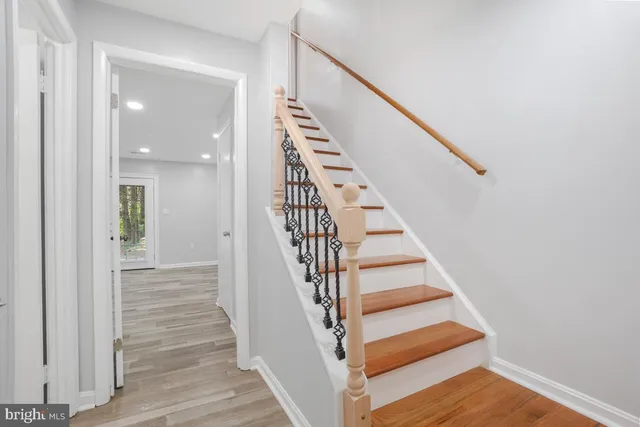 a view of entryway and hall with wooden floor