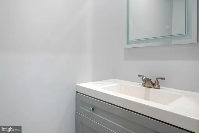 a bathroom with a sink and mirror
