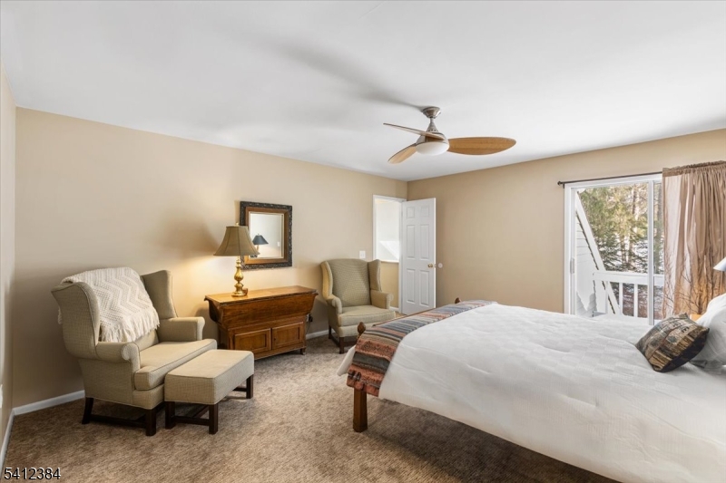 10 Gristmill Sparta, NJ 07871 - Photo 24 of 35 a bedroom with a bed a couch and a window