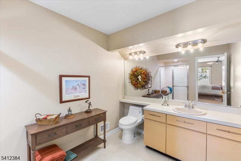10 Gristmill Sparta, NJ 07871 - Photo 25 of 35 a bathroom with a double vanity sink mirror and toilet