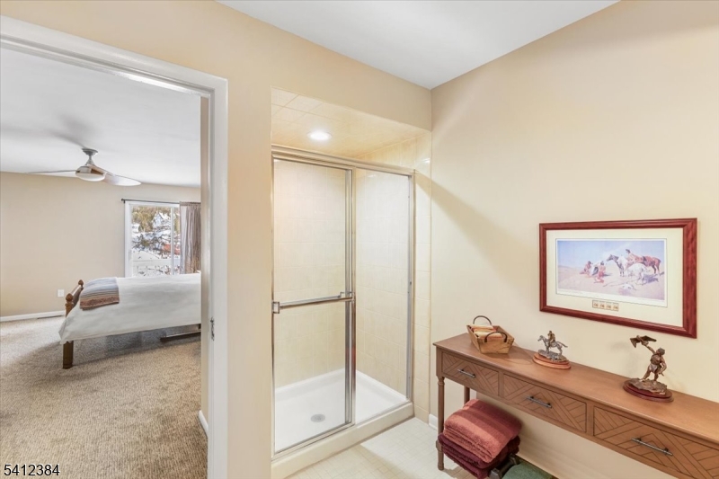 10 Gristmill Sparta, NJ 07871 - Photo 26 of 35 a living room with furniture and a painting on the wall