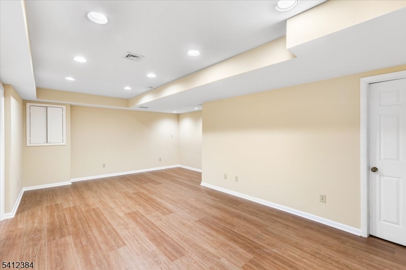 10 Gristmill Sparta, NJ 07871 - Photo 33 of 35 an empty room with wooden floor and windows