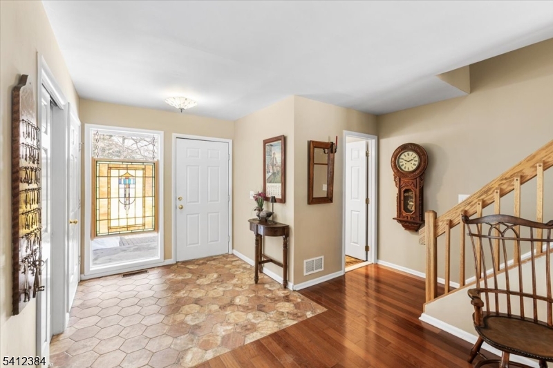 10 Gristmill Sparta, NJ 07871 - Photo 5 of 35 a view of an entryway with wooden floor and a livingroom