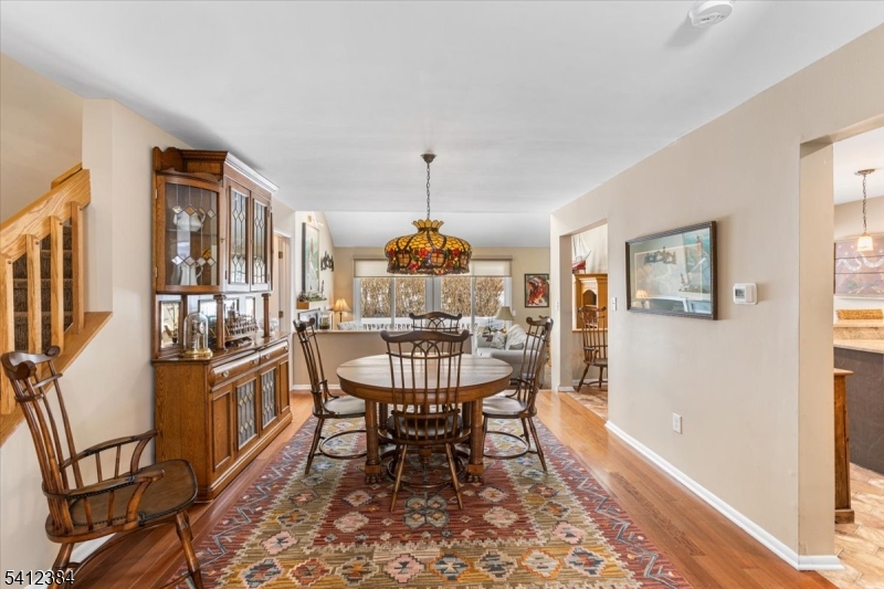 10 Gristmill Sparta, NJ 07871 - Photo 6 of 35 a dining room with furniture a chandelier and wooden floor