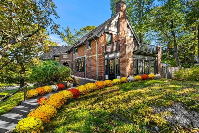 a living room with furniture a fireplace and a potted plant