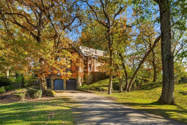 a large kitchen with kitchen island a stove a sink dishwasher and a dining table with wooden floor