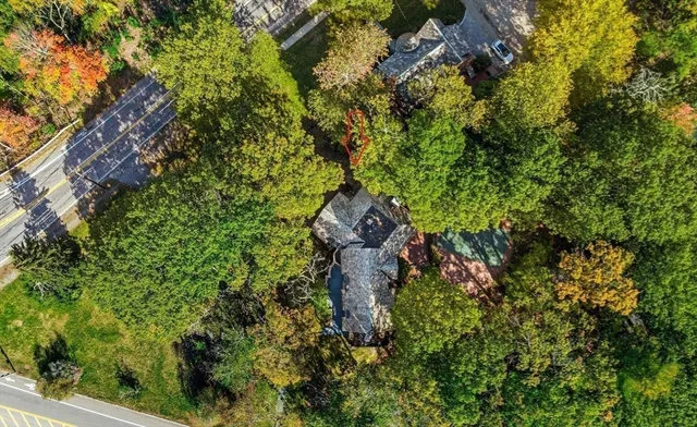a living room with furniture a chandelier and a dining table