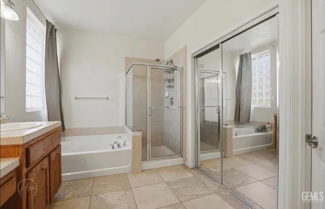 a bathroom with a tub shower and a sink