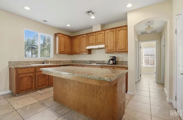 a kitchen with stainless steel appliances granite countertop a sink and cabinets