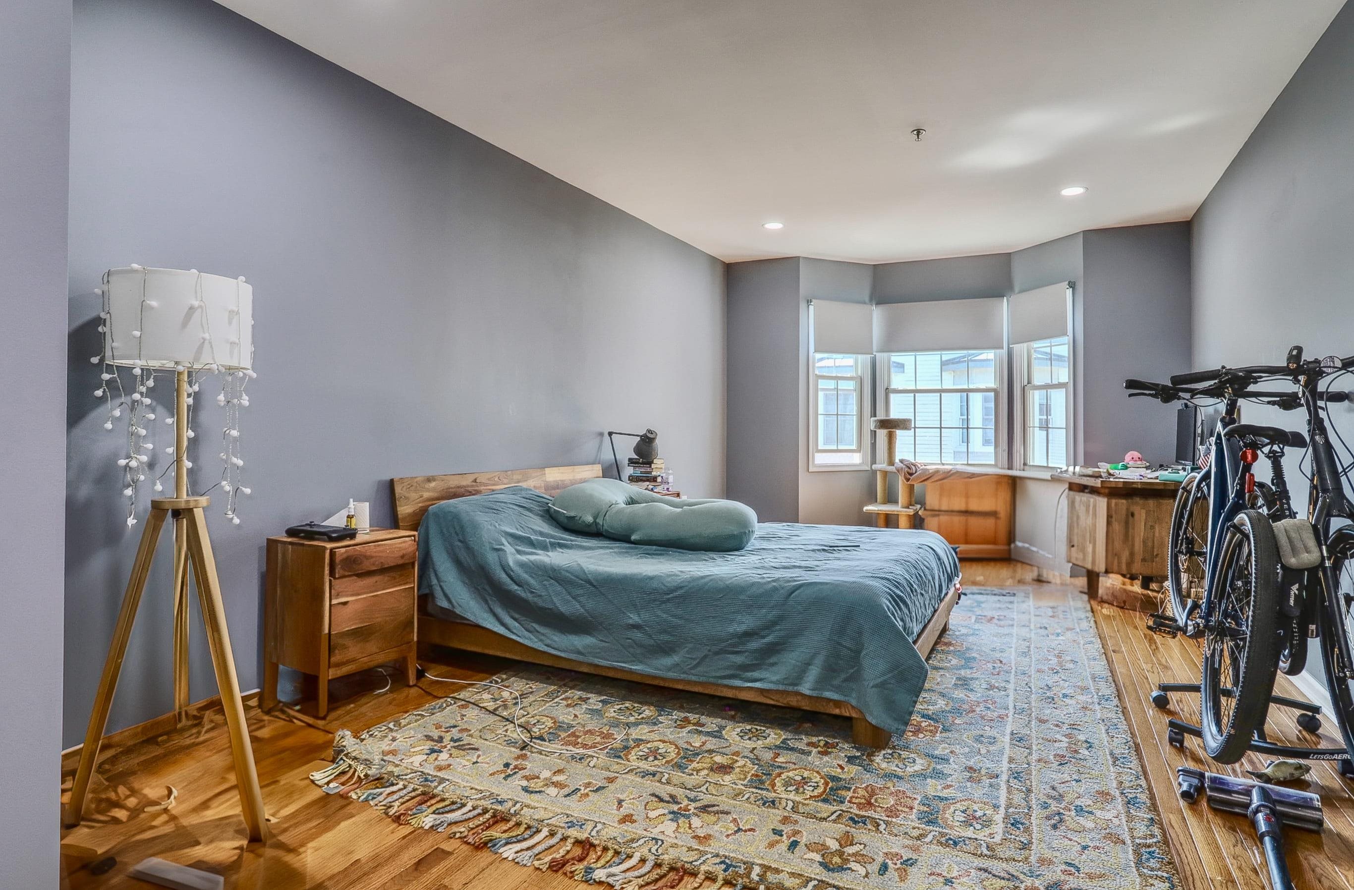 340 The Promenade, Unit 340 Edgewater, NJ 07020 - Photo 12 of 20 a bedroom with a bed furniture and a window