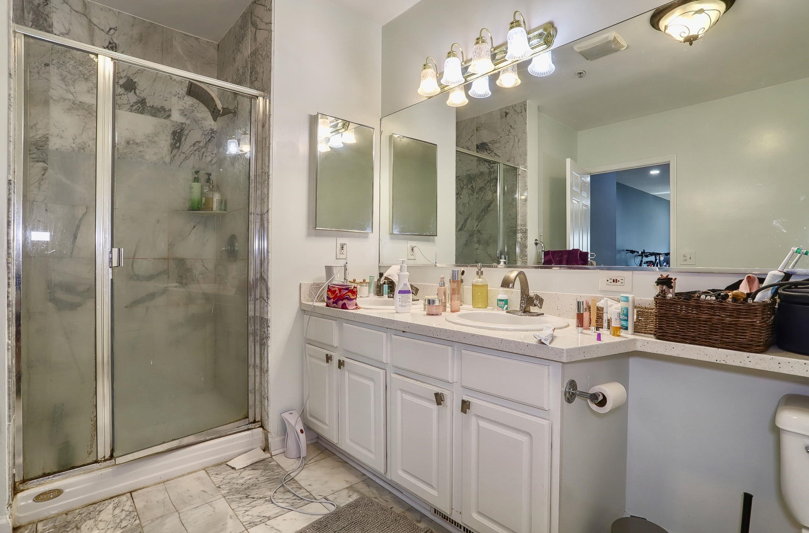 340 The Promenade, Unit 340 Edgewater, NJ 07020 - Photo 15 of 20 a bathroom with a double vanity sink mirror and shower