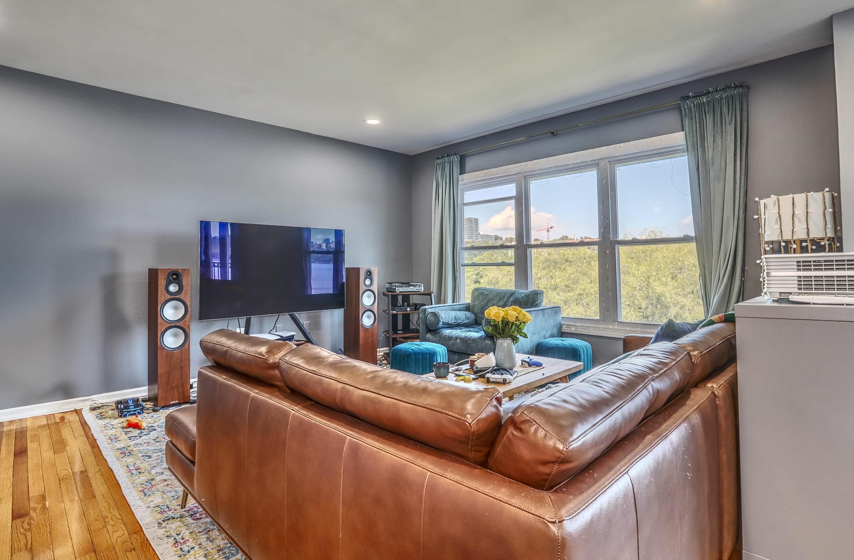 340 The Promenade, Unit 340 Edgewater, NJ 07020 - Photo 4 of 20 a living room with furniture and a flat screen tv