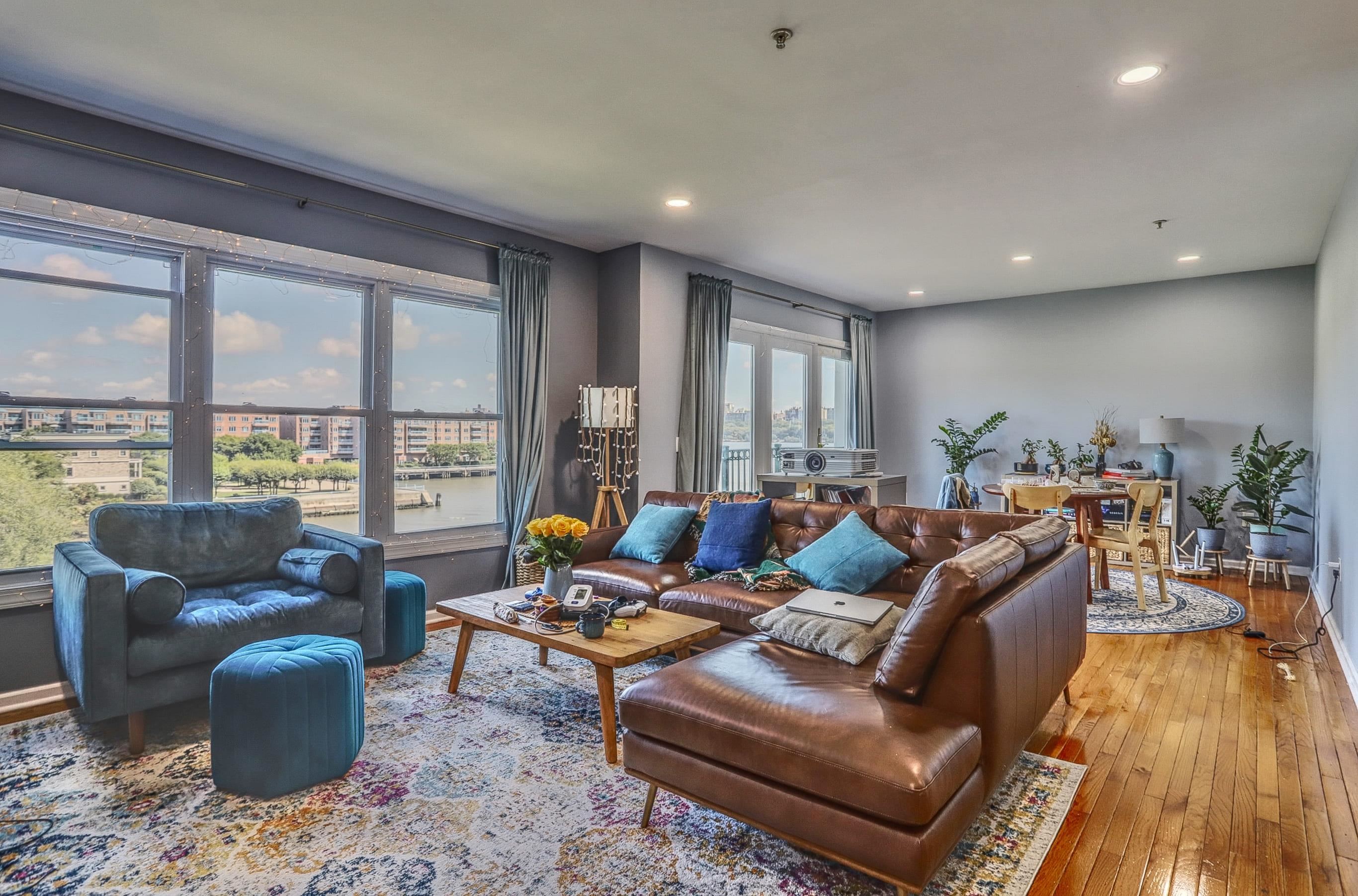 340 The Promenade, Unit 340 Edgewater, NJ 07020 - Photo 5 of 20 a living room with furniture and a wooden floor
