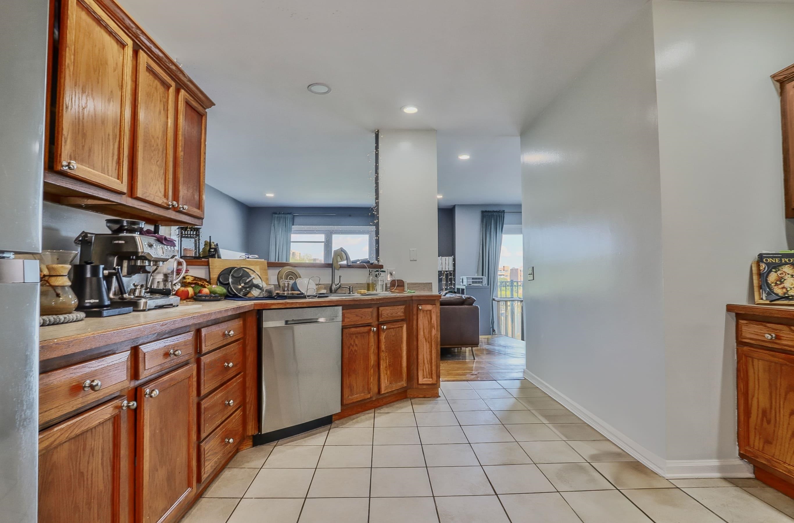 340 The Promenade, Unit 340 Edgewater, NJ 07020 - Photo 9 of 20 a kitchen with stainless steel appliances granite countertop a refrigerator and a sink