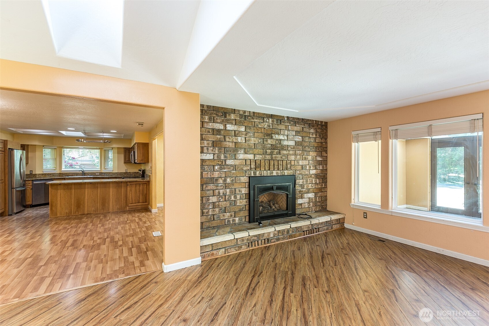 123 Forest Ridge Drive Sequim, WA 98382 - Photo 15 of 32 wooden floor fireplace and windows in an empty room