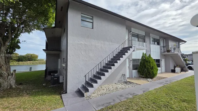 a view of a house with a yard patio and a small yard