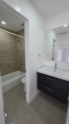 a bathroom with a bathtub and a toilet