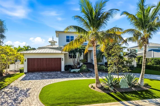 a view of a house with swimming pool and sitting area