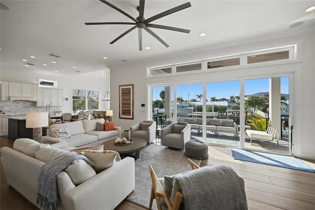 a open kitchen with stainless steel appliances granite countertop a sink a stove and a refrigerator