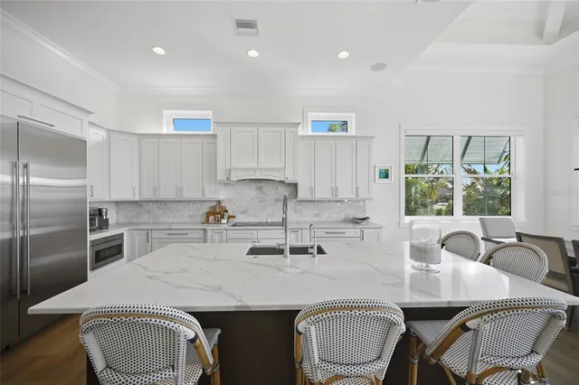 a kitchen with stainless steel appliances granite countertop a sink stove and cabinets