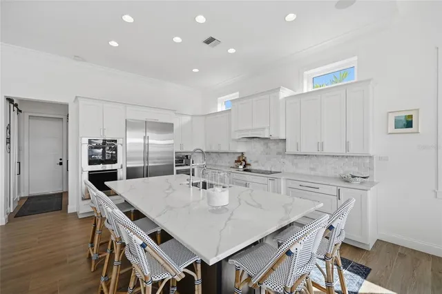 a kitchen with stainless steel appliances granite countertop a sink and cabinets