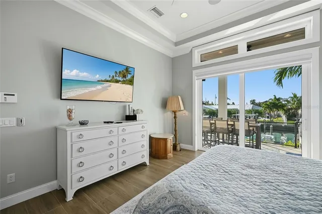 a bedroom with a bed couch and a large window