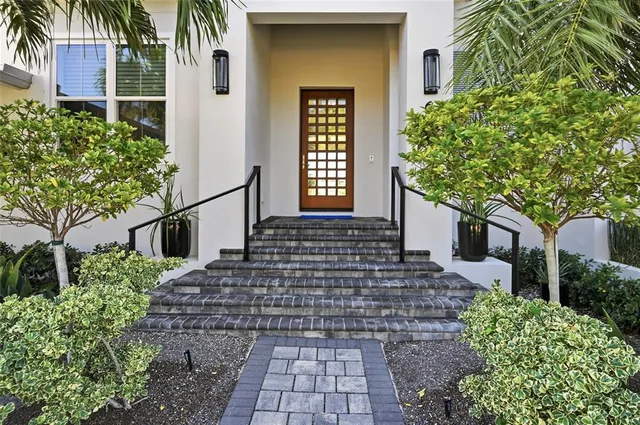 a living room with furniture a large window and a dining table