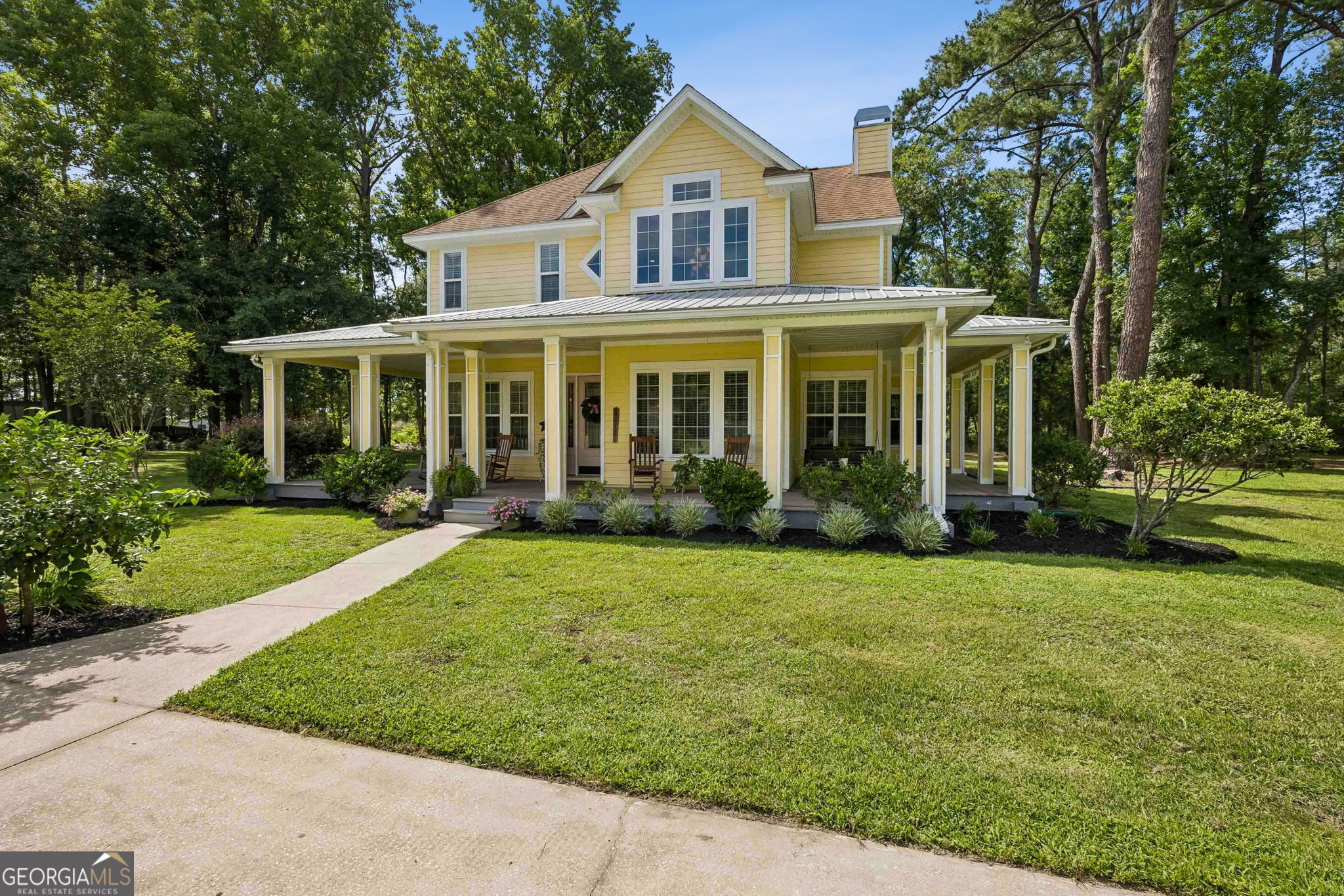 706 Hopewell Point Road White Oak, GA 31568 - Photo 54 of 84 The wraparound porch offers the perfect place to enjoy morning coffee, unwind in the evening, or take in the peaceful surroundings.