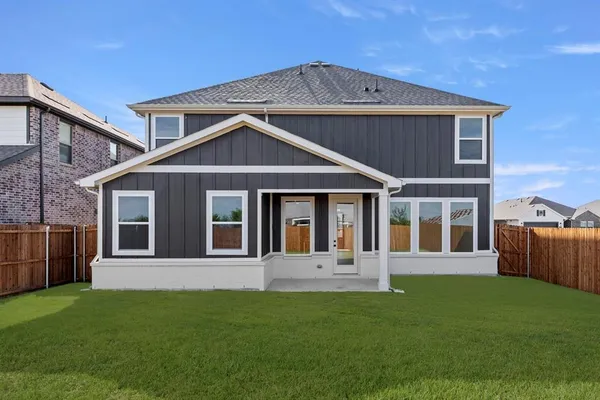 an aerial view of a swimming pool with a yard and lake view