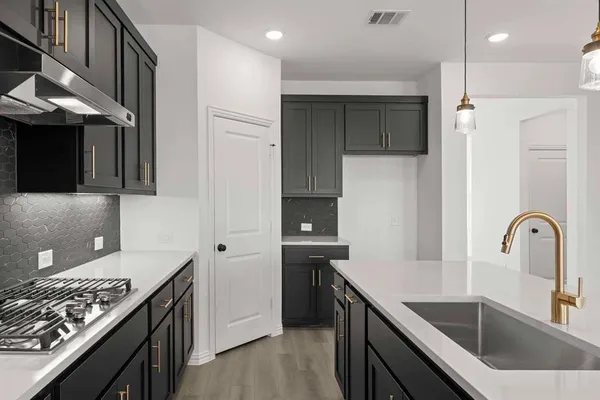 a kitchen with a sink and a refrigerator