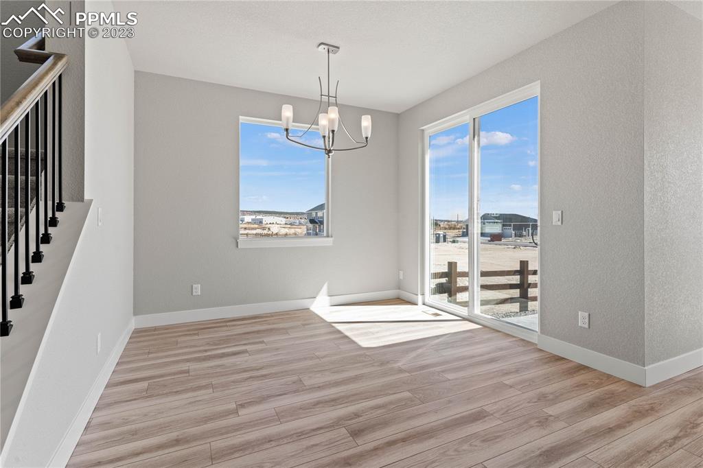 2155 Coyote Mint Drive Monument, CO 80132 - Photo 19 of 45 a view of an empty room with wooden floor and a window