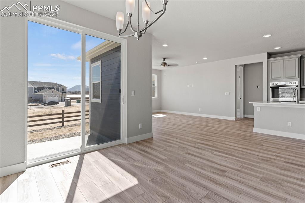 2155 Coyote Mint Drive Monument, CO 80132 - Photo 20 of 45 a view of a room with wooden floor and a large window