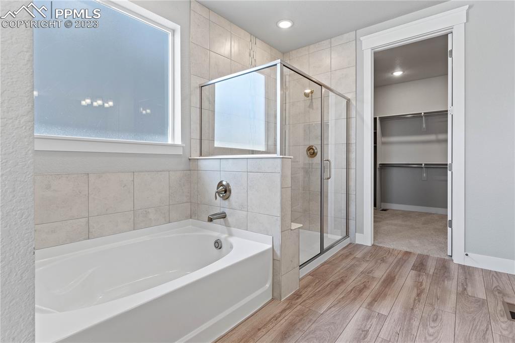 2155 Coyote Mint Drive Monument, CO 80132 - Photo 24 of 45 a bathroom with a bathtub and a shower