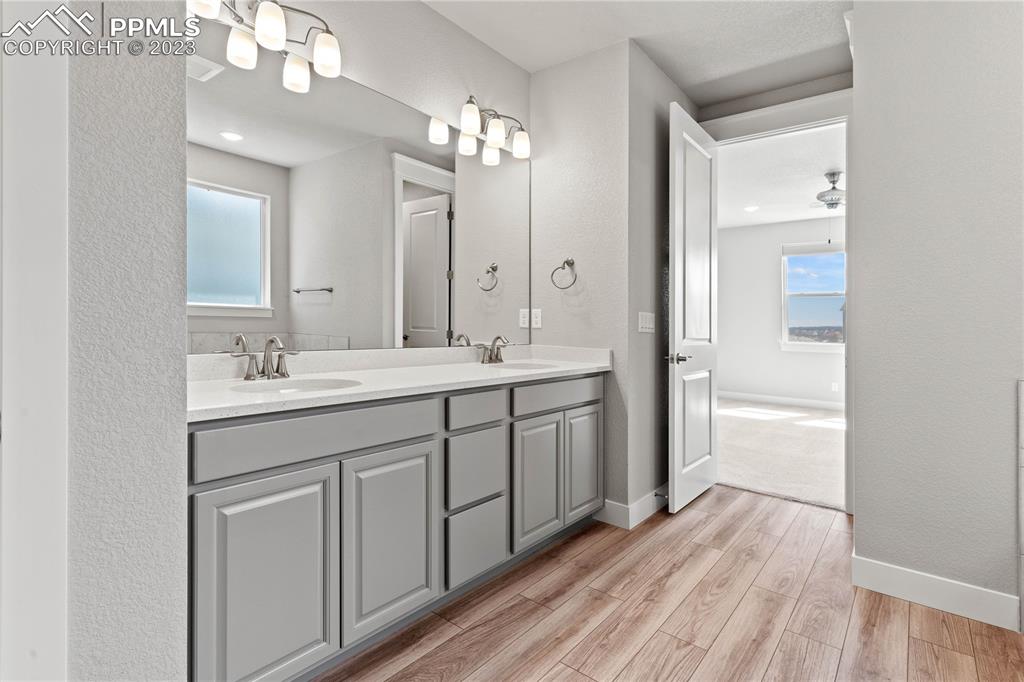 2155 Coyote Mint Drive Monument, CO 80132 - Photo 25 of 45 a spacious bathroom with a double vanity sink a mirror and a shower