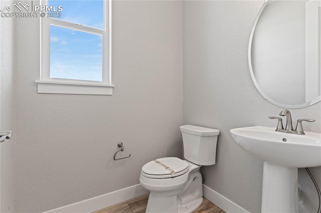 2155 Coyote Mint Drive Monument, CO 80132 - Photo 7 of 45 a bathroom with a sink a toilet and a mirror