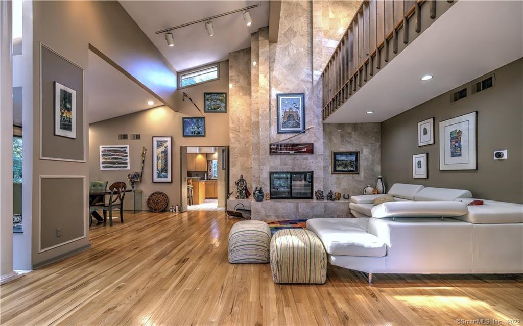 a living room with fireplace furniture and a wooden floor