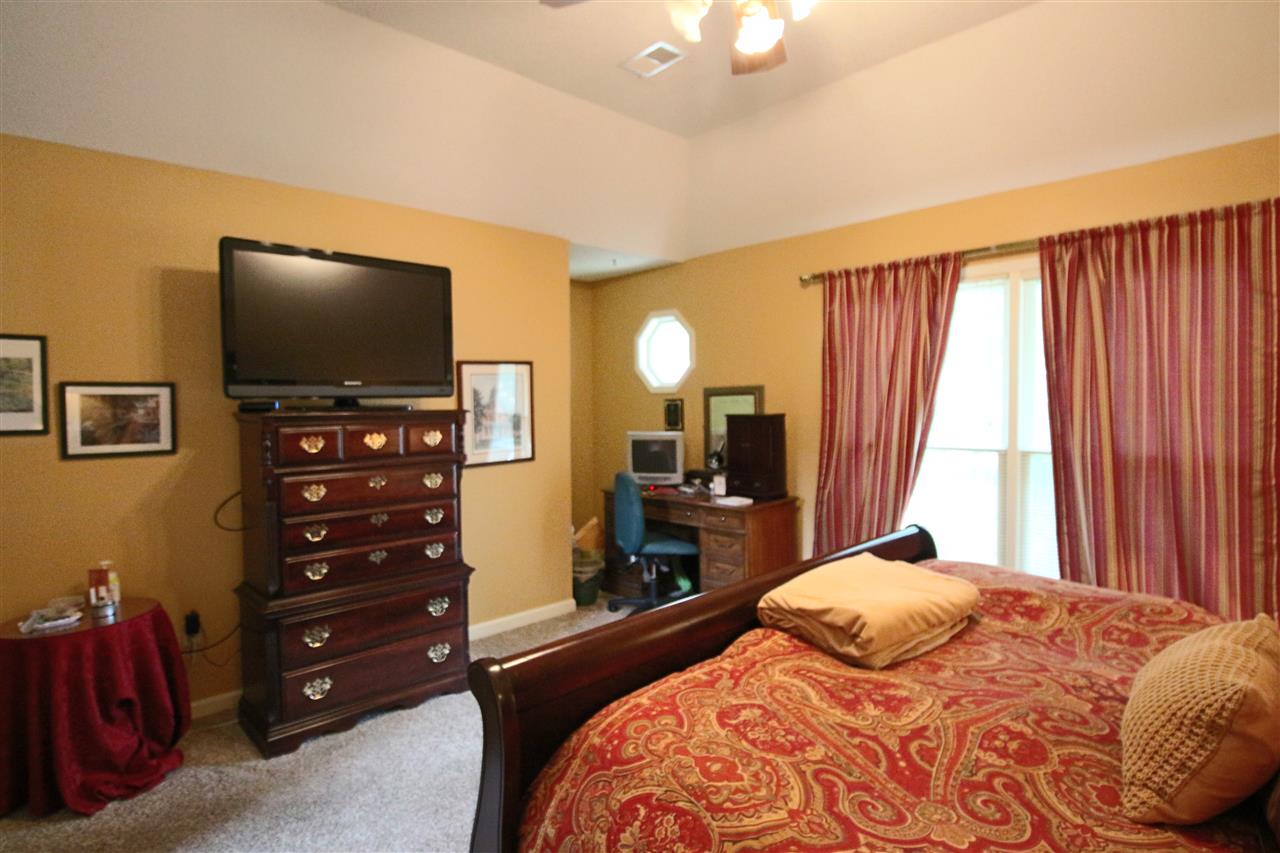 8541 Bazemore Road Memphis, TN 38018 - Photo 14 of 24 a bedroom with a bed and a flat tv screen on dresser