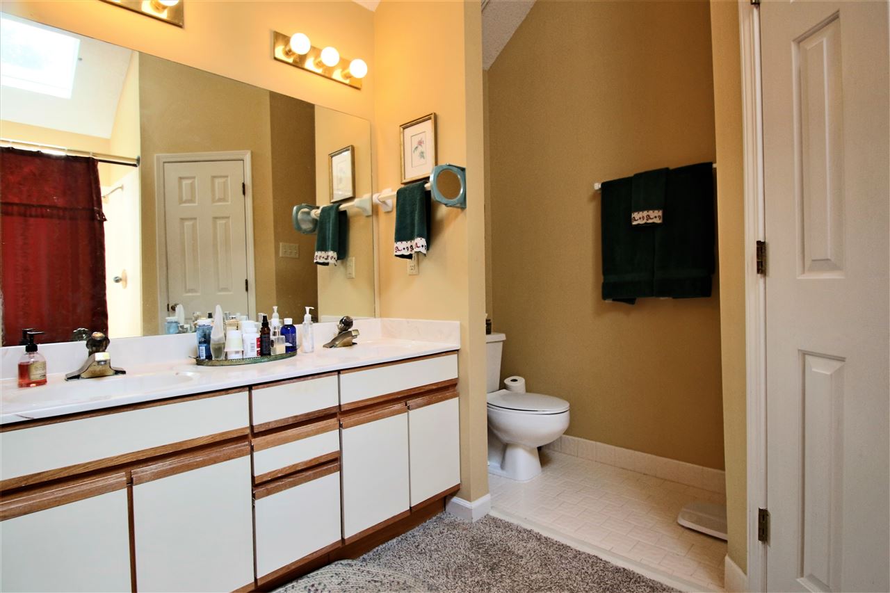 8541 Bazemore Road Memphis, TN 38018 - Photo 15 of 24 a bathroom with a sink a toilet a mirror and shower