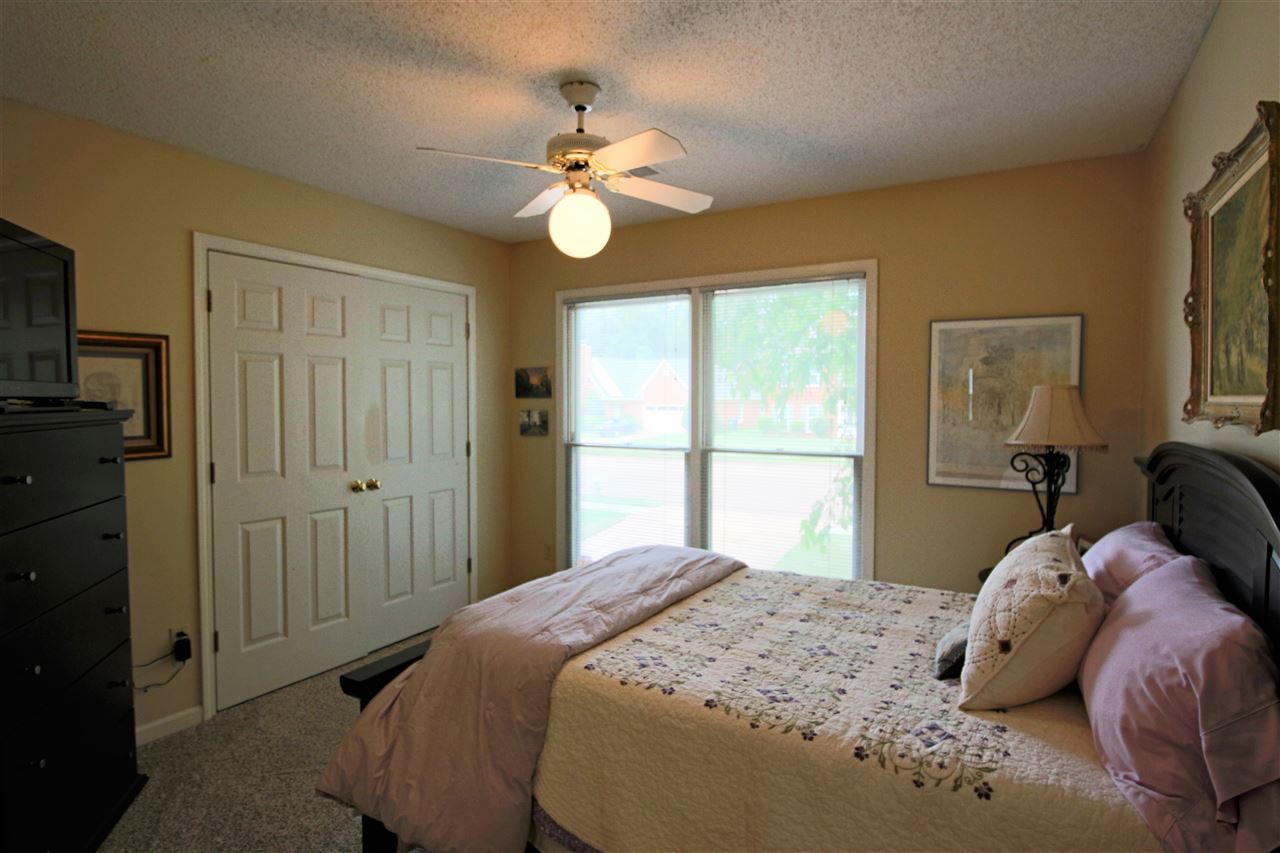 8541 Bazemore Road Memphis, TN 38018 - Photo 17 of 24 a bedroom with a bed and a chandelier