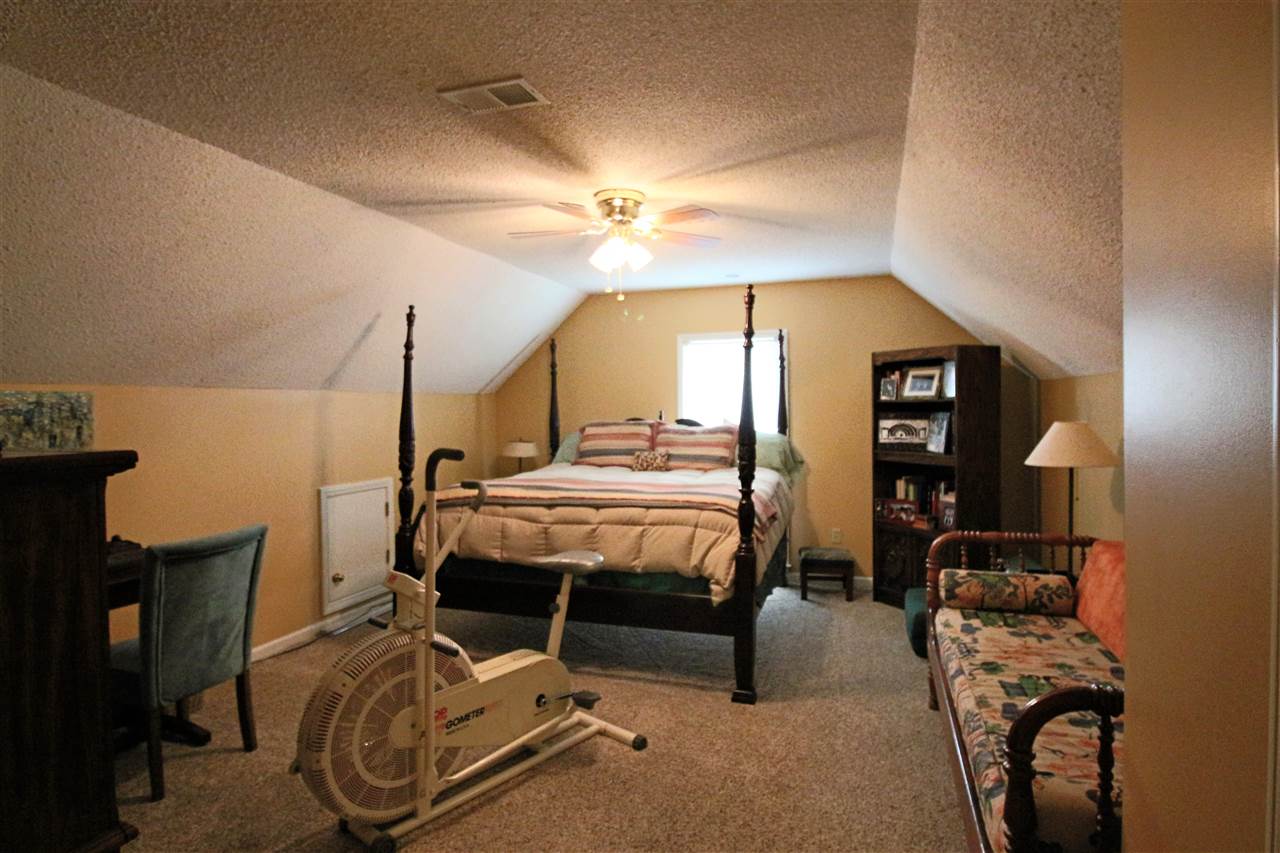 8541 Bazemore Road Memphis, TN 38018 - Photo 18 of 24 a bedroom with bed and a chandelier