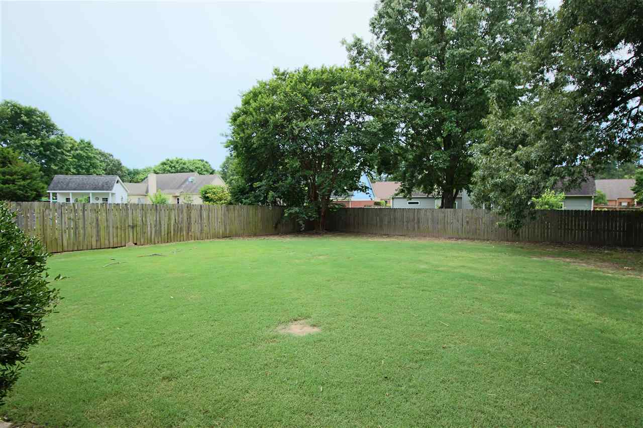 8541 Bazemore Road Memphis, TN 38018 - Photo 23 of 24 a backyard of a house with lots of green space