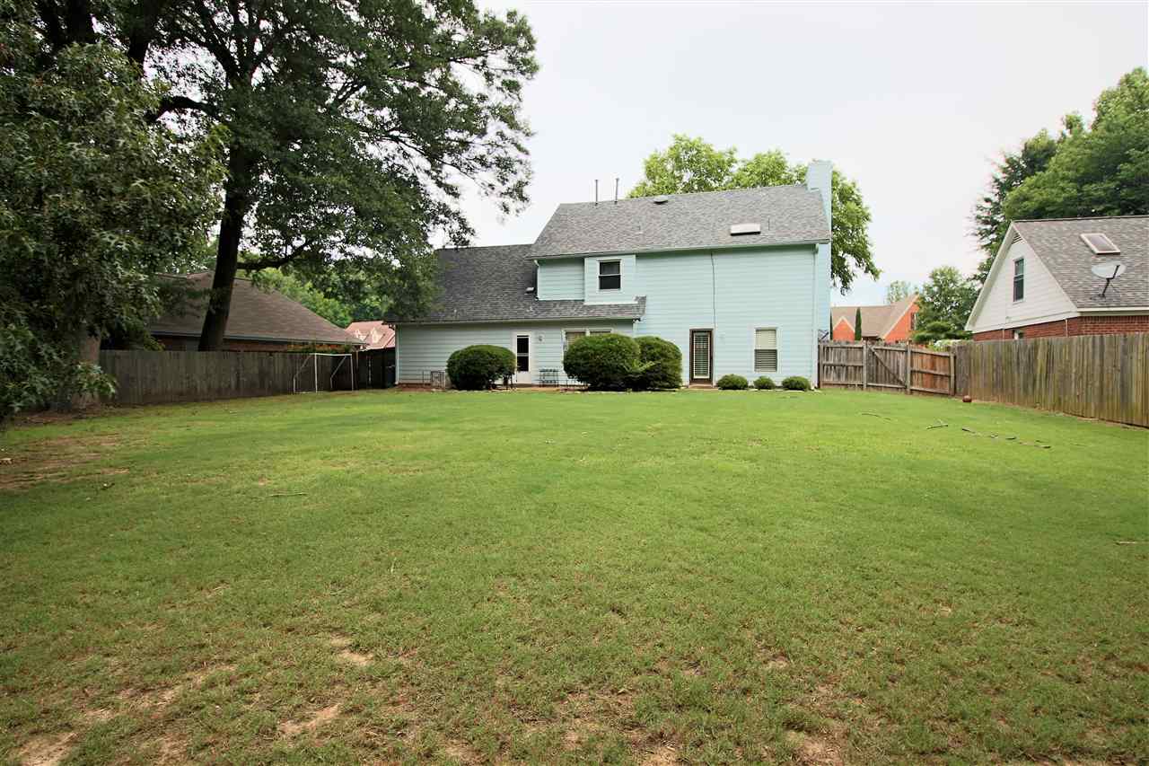 8541 Bazemore Road Memphis, TN 38018 - Photo 24 of 24 a view of a house with a yard and a large tree