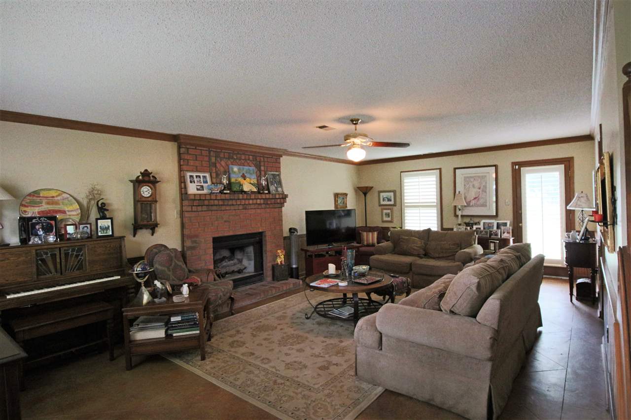 8541 Bazemore Road Memphis, TN 38018 - Photo 3 of 24 a living room with furniture a fireplace and a flat screen tv