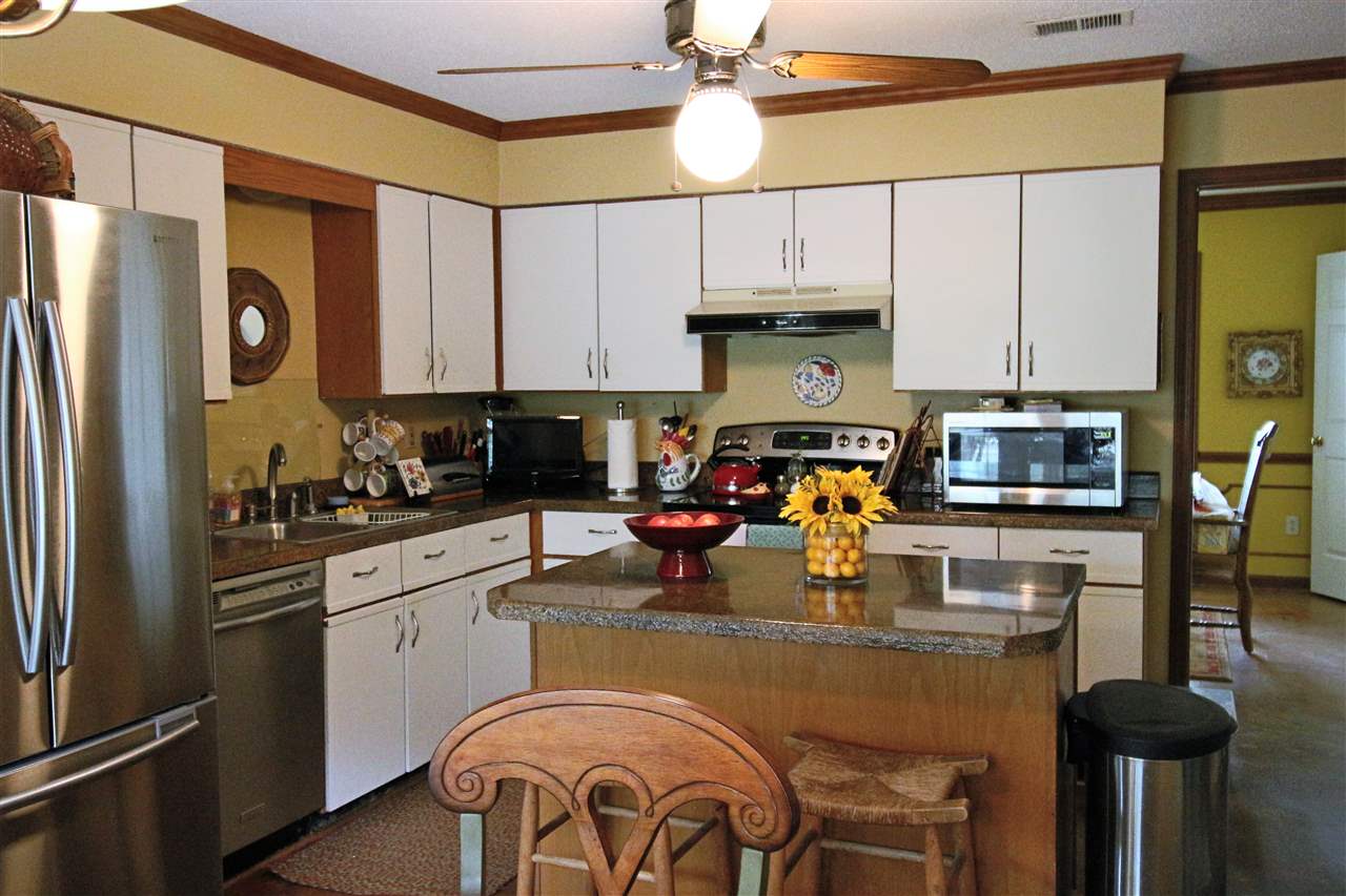 8541 Bazemore Road Memphis, TN 38018 - Photo 9 of 24 a kitchen with a refrigerator and a stove top oven