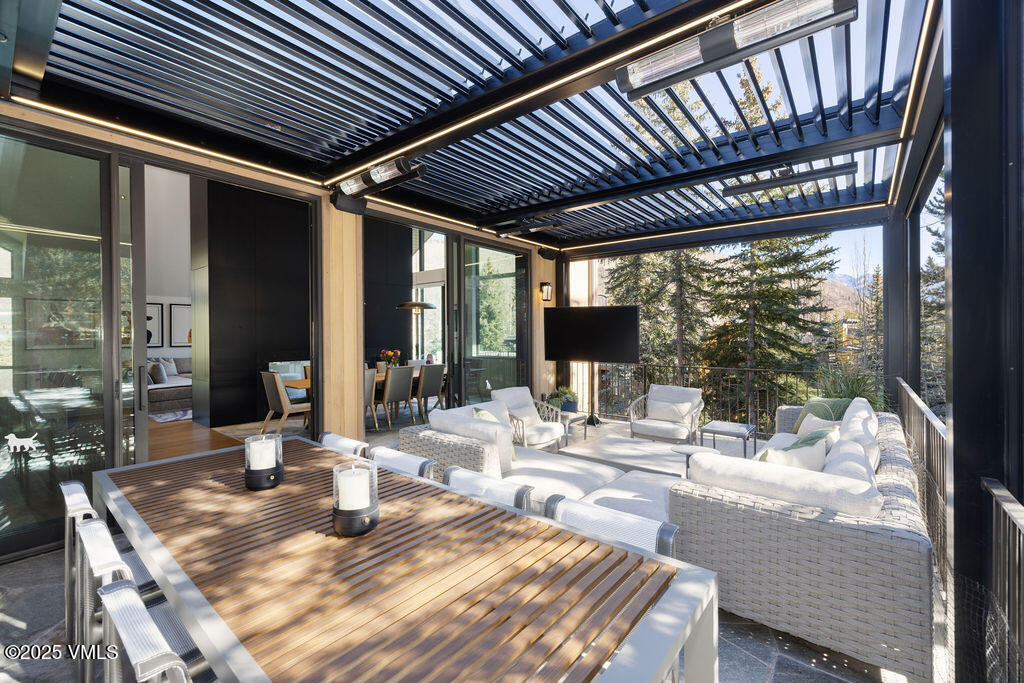 254 Beaver Dam Road Vail, CO 81657 - Photo 14 of 46 a view of a patio with a table and chairs and couches