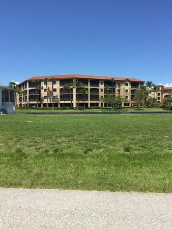 a view of a big yard with a house in the background