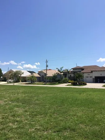 a view of a grassy field with an trees