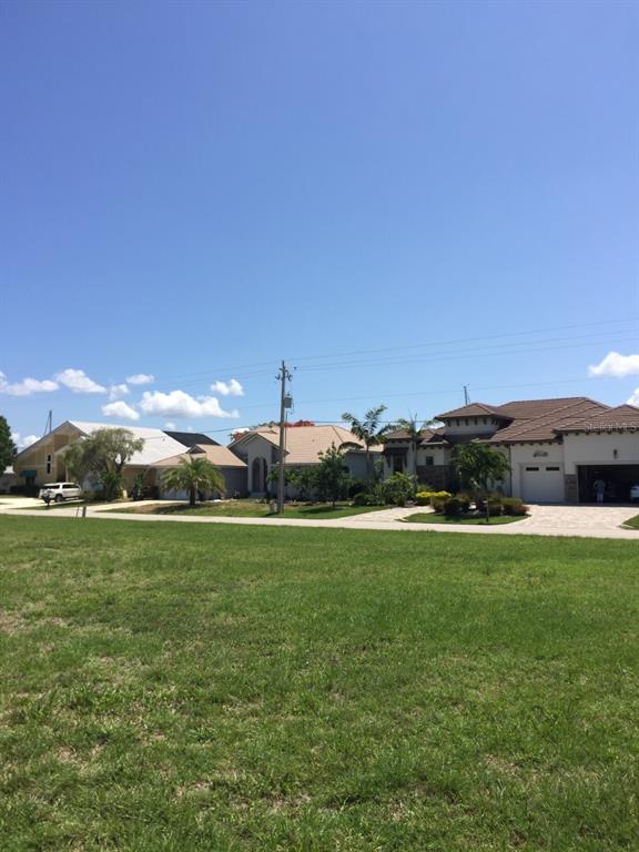 85 Colony Point Drive Punta Gorda, FL 33950 - Photo 5 of 9 a view of a grassy field with an trees