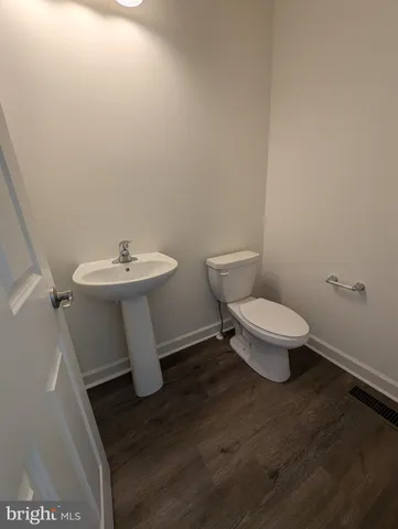 a white toilet sitting next to a sink